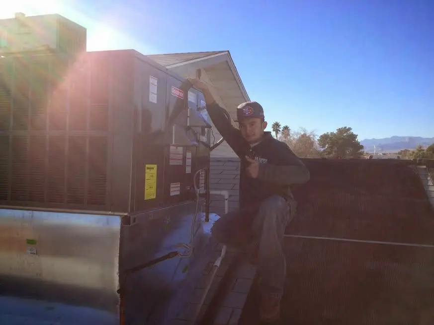 HVAC technician performing Air Duct Repair on a rooftop unit in East Renton Highlands